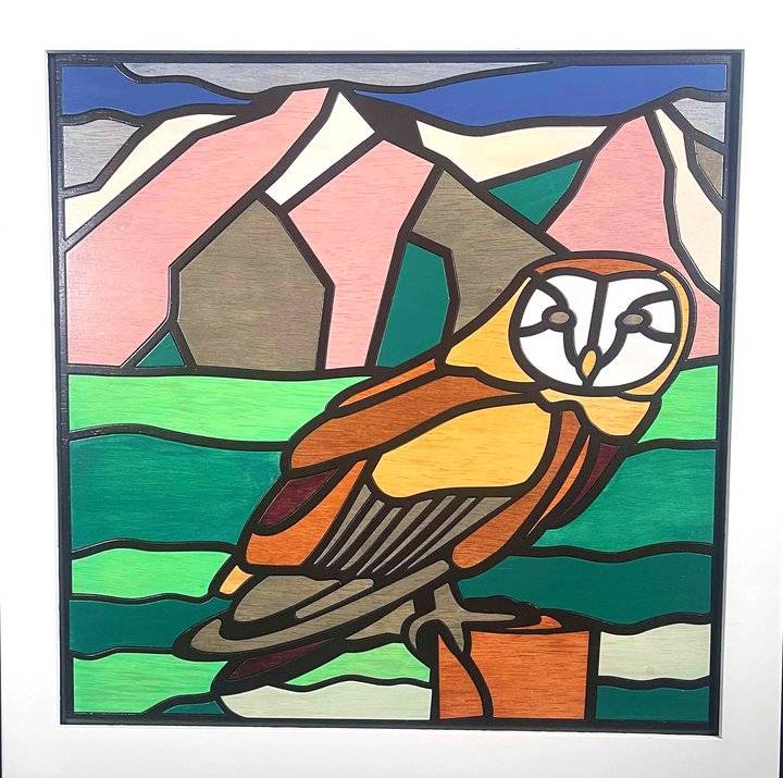 White wood framed quilt of an owl